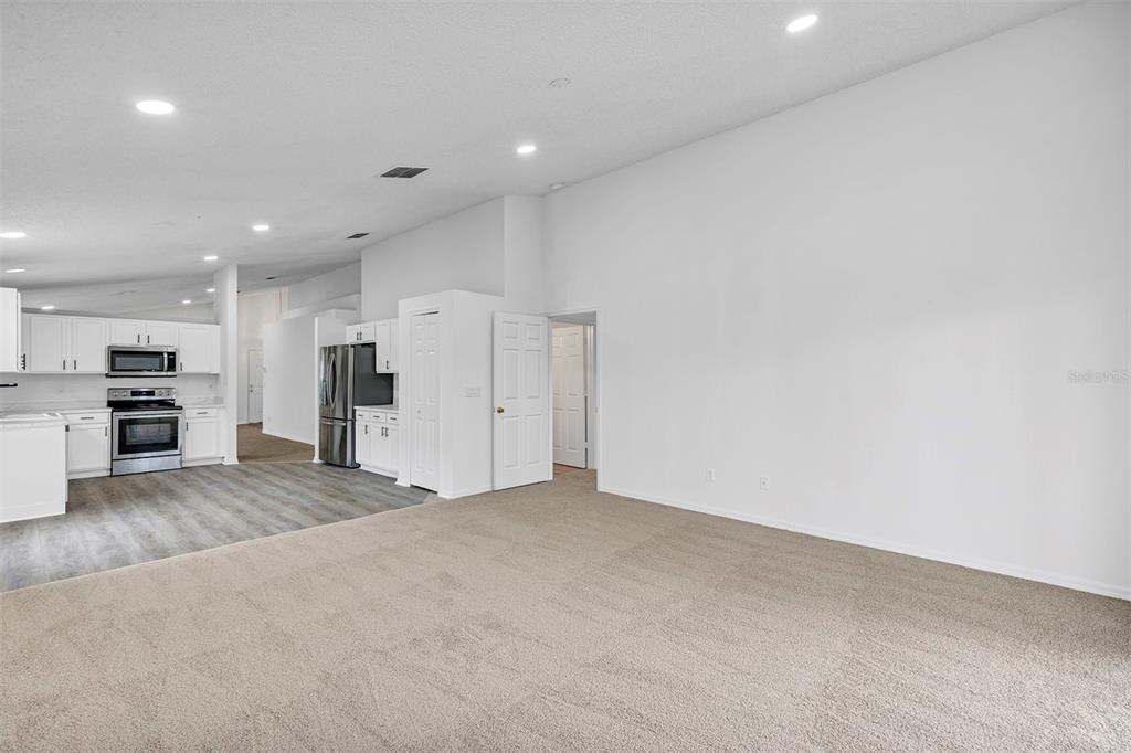 4254 Northern Dancer Way Orlando, FL 32826 - Photo 14 of 38 an empty room with a kitchen