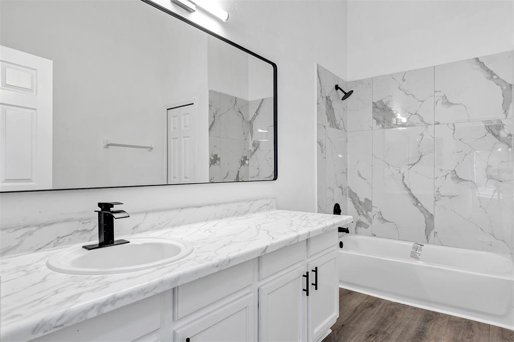 4254 Northern Dancer Way Orlando, FL 32826 - Photo 18 of 38 a bathroom with a tub sink and mirror