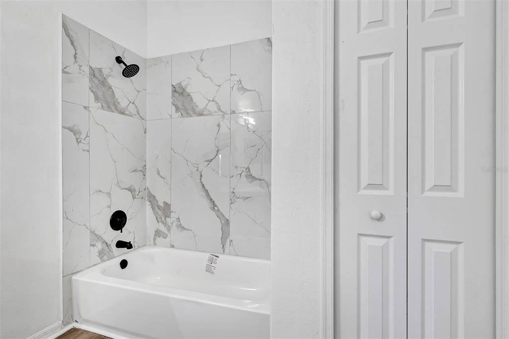 4254 Northern Dancer Way Orlando, FL 32826 - Photo 20 of 38 a bathroom with a bathtub