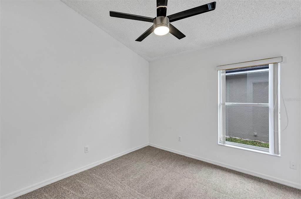 4254 Northern Dancer Way Orlando, FL 32826 - Photo 28 of 38 an empty room with a window and a ceiling fan