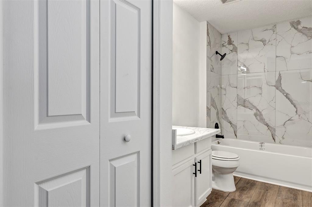 4254 Northern Dancer Way Orlando, FL 32826 - Photo 34 of 38 a bathroom with a toilet a sink and bathtub