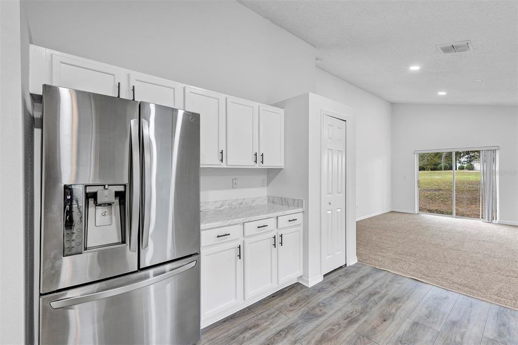 4254 Northern Dancer Way Orlando, FL 32826 - Photo 6 of 38 a kitchen with stainless steel appliances a refrigerator and a sink