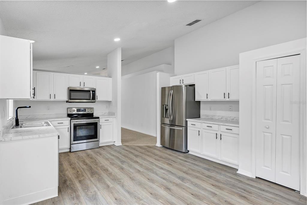 4254 Northern Dancer Way Orlando, FL 32826 - Photo 9 of 38 a kitchen with granite countertop a refrigerator stove and oven