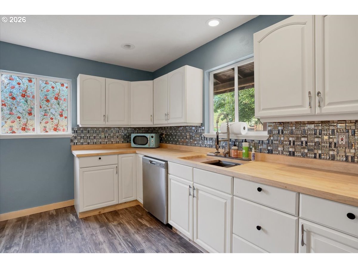 566 North Bear Creek Road Otis, OR 97368 - Photo 11 of 40 a kitchen with a sink window and cabinets