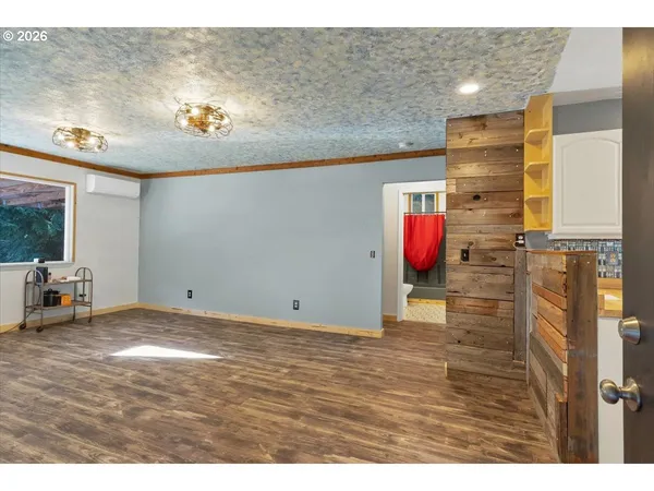 a view of an empty room with a kitchen