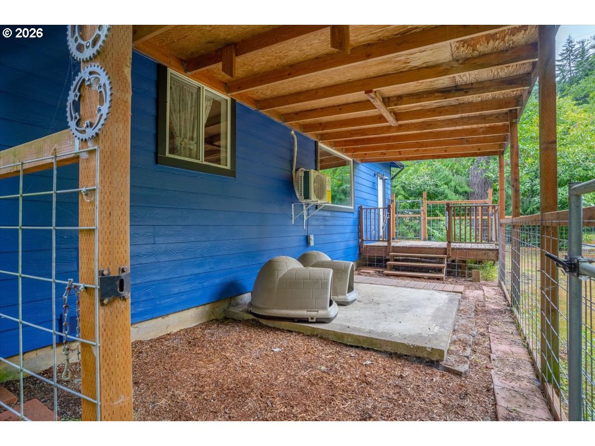566 North Bear Creek Road Otis, OR 97368 - Photo 23 of 40 a backyard of a house with table and chairs