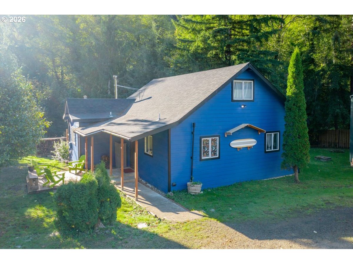 566 North Bear Creek Road Otis, OR 97368 - Photo 38 of 40 a aerial view of a house with a yard