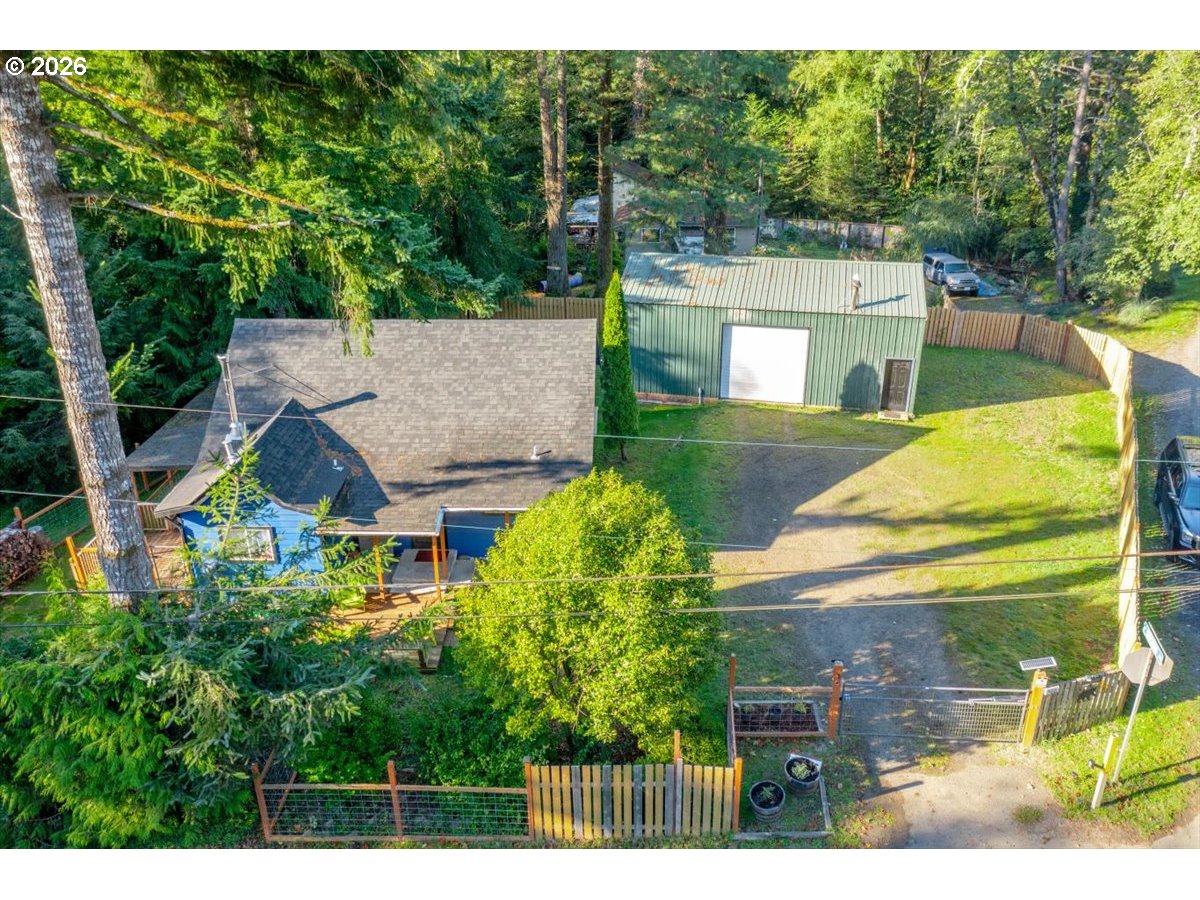 566 North Bear Creek Road Otis, OR 97368 - Photo 7 of 40 a view of a house with a yard and a large tree