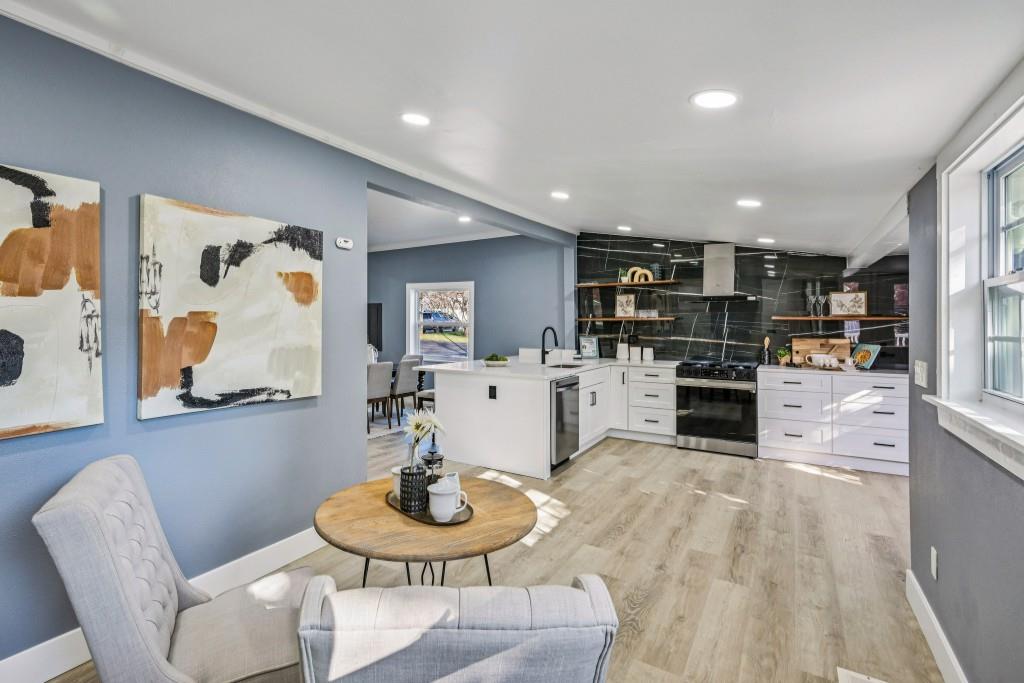 1504 Hardin Avenue Atlanta, GA 30337 - Photo 21 of 50 a kitchen with stainless steel appliances kitchen island granite countertop a table and chairs in it