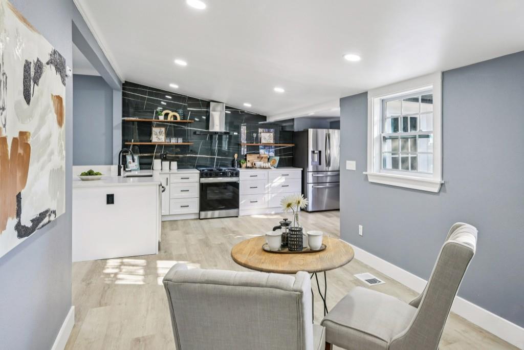 1504 Hardin Avenue Atlanta, GA 30337 - Photo 22 of 50 a living room with stainless steel appliances furniture a dining table and kitchen view