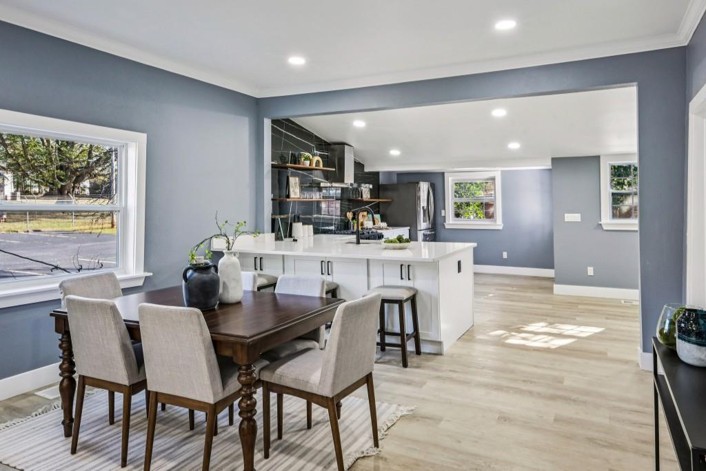 1504 Hardin Avenue Atlanta, GA 30337 - Photo 9 of 50 a dining room with stainless steel appliances kitchen island granite countertop a table chairs and a refrigerator
