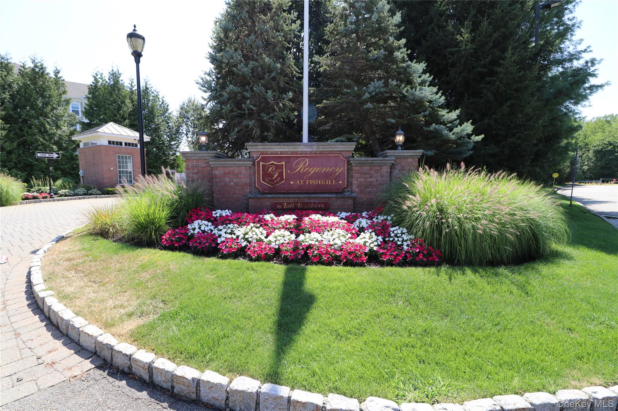 Community / neighborhood sign with a yard