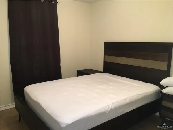 a bedroom with a bed and a cabinet