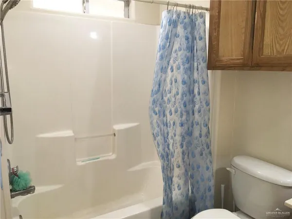a bathroom with a toilet and shower
