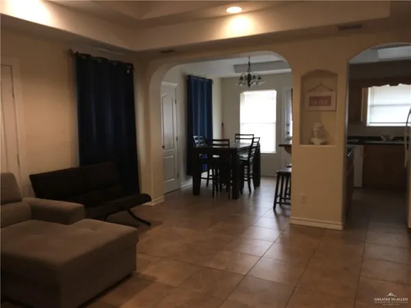 a dining room with furniture and a chandelier