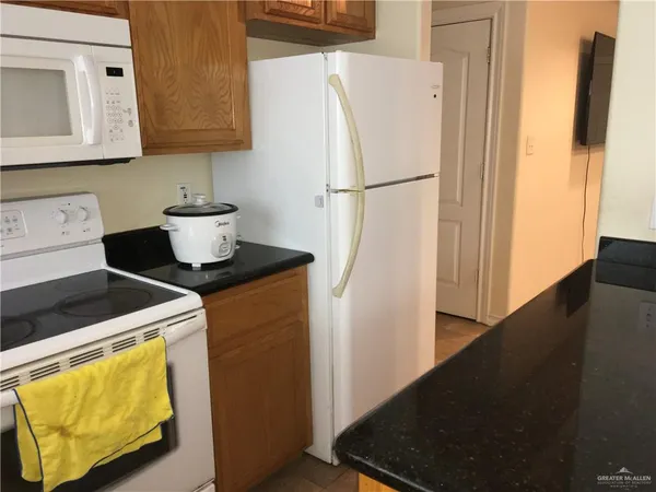a kitchen with a refrigerator and a stove