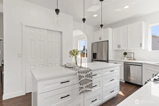 a kitchen with cabinets appliances and a counter space