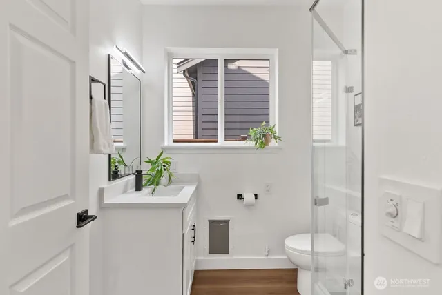 a bathroom with a sink mirror vanity and toilet
