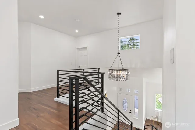 a view of entryway and hall with wooden floor
