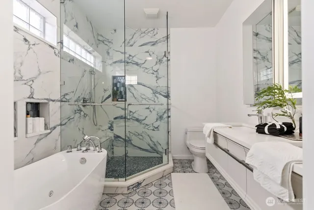 a bathroom with a sink a toilet and shower