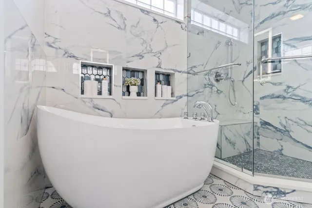 a white bath tub sitting in a bathroom
