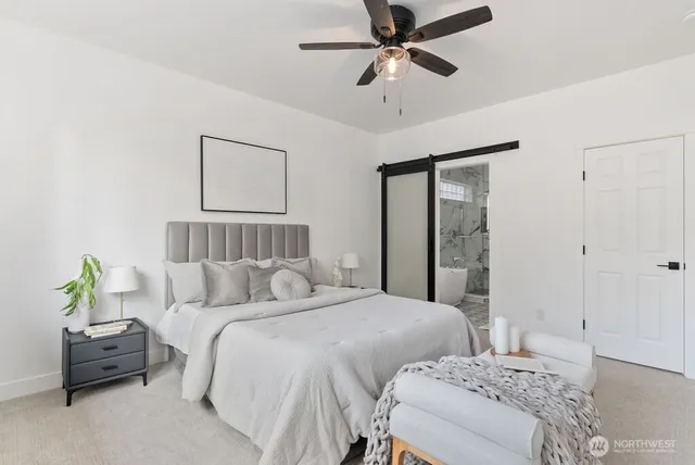 a bedroom with a bed couch and window