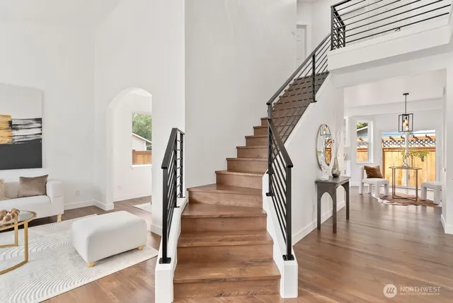 a view of entryway and hall with wooden floor