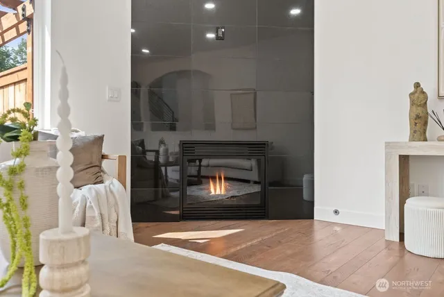 a living room with furniture a fireplace and a potted plant