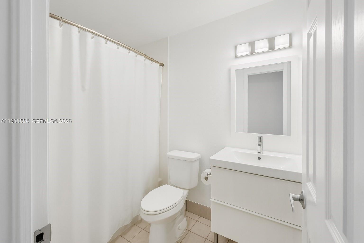 3250 Southwest 116th Place Miami, FL 33165 - Photo 11 of 15 a bathroom with a sink a toilet and a mirror