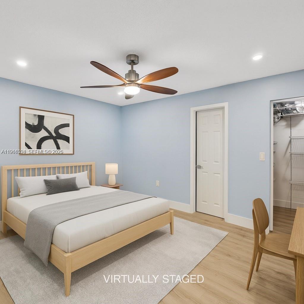 3250 Southwest 116th Place Miami, FL 33165 - Photo 6 of 15 a bedroom with a bed a chair and potted plant