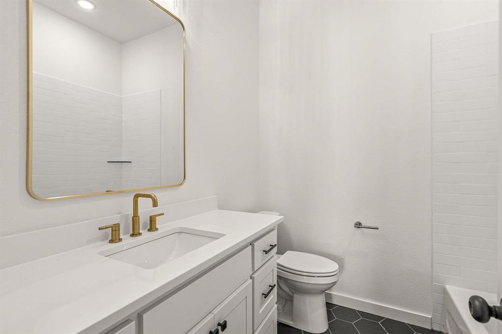 177 Hulen Circle Aledo, TX 76008 - Photo 14 of 21 a bathroom with a sink a toilet and a mirror