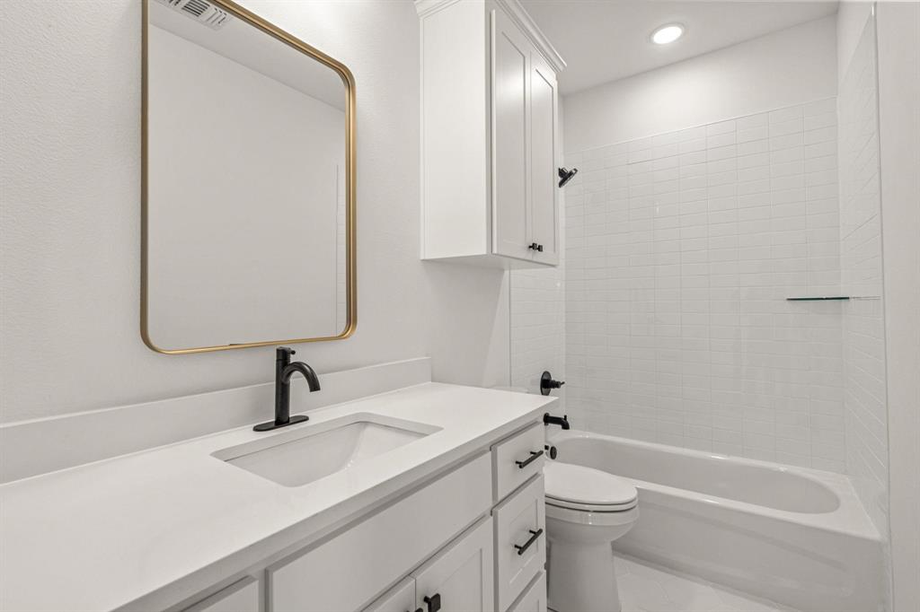 177 Hulen Circle Aledo, TX 76008 - Photo 16 of 21 a bathroom with a sink a toilet and shower