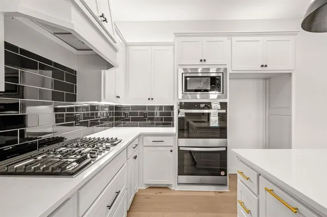 a kitchen with a stove and a microwave