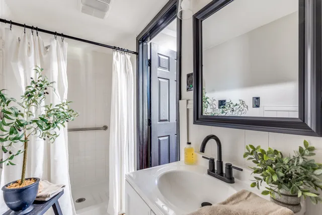 a view of a big room with wooden floor and windows