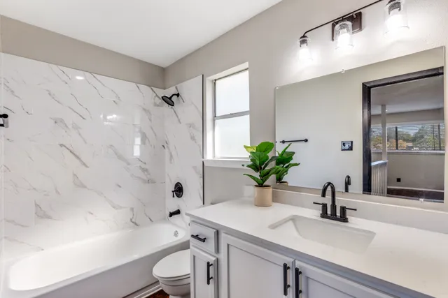 a bathroom with a sink a mirror and a shower
