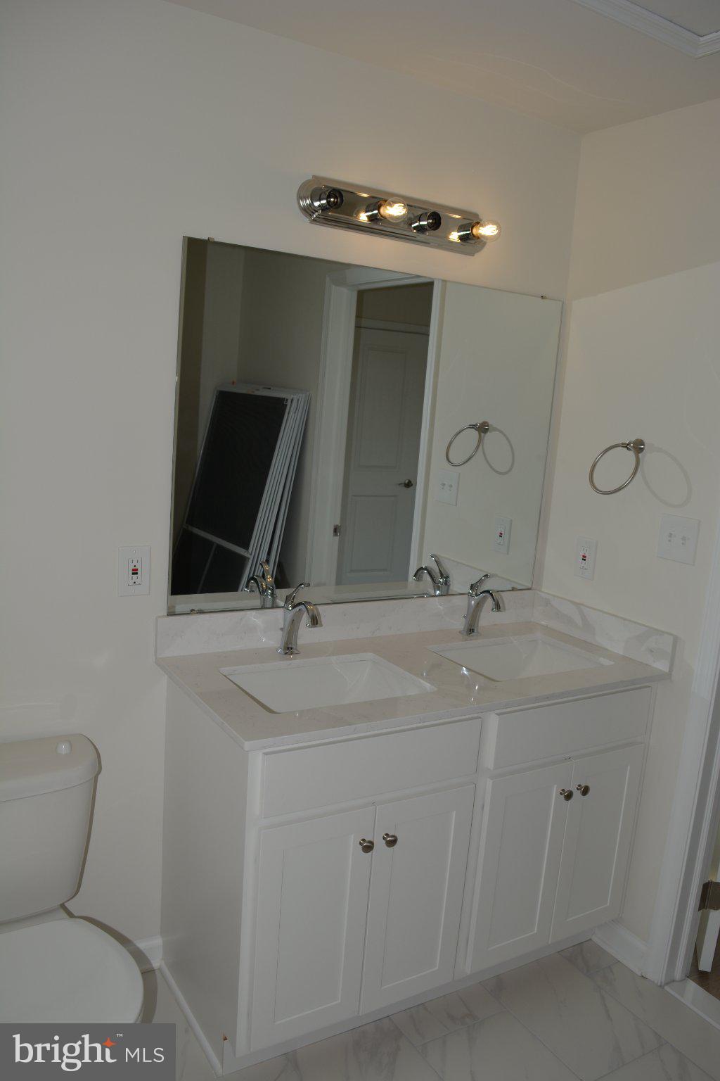 7631 Ridge Avenue, Unit 3 Philadelphia, PA 19128 - Photo 14 of 16 Sleek dual vanity in modern bathroom.