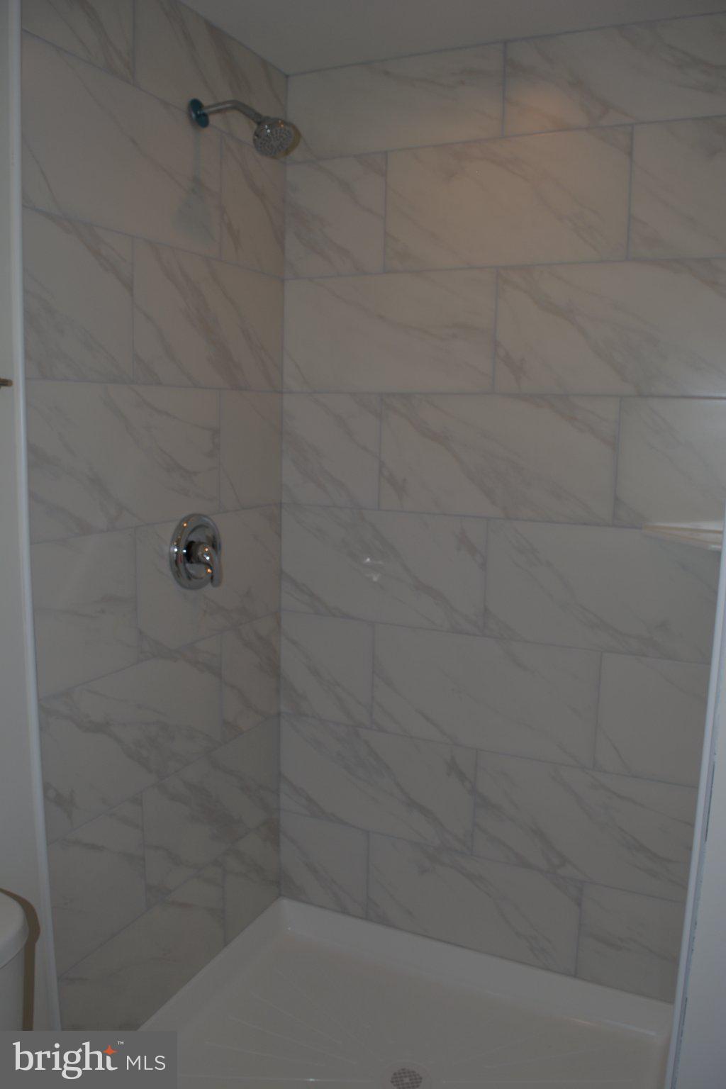 7631 Ridge Avenue, Unit 3 Philadelphia, PA 19128 - Photo 16 of 16 Sleek marble shower retreat.