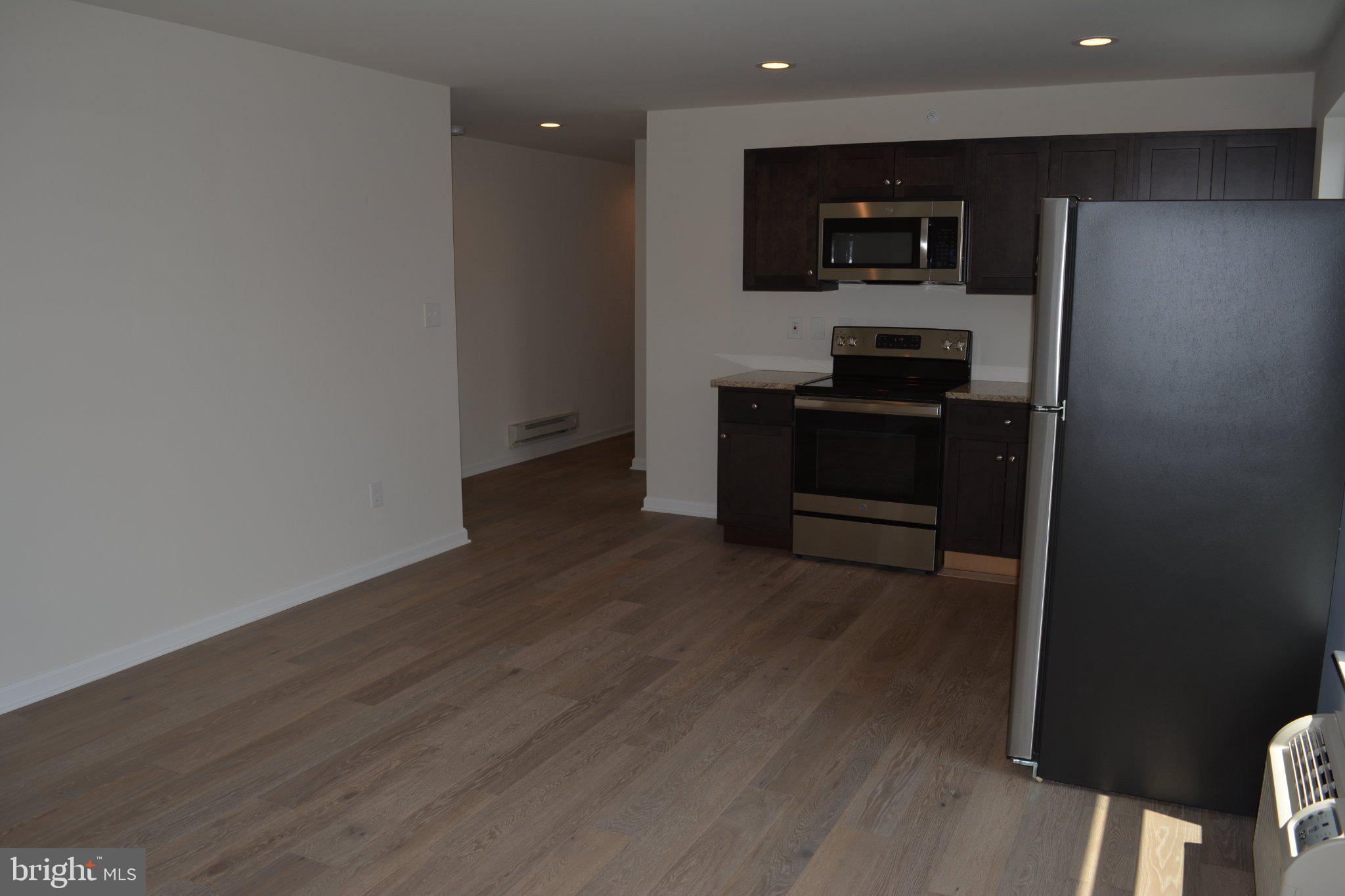 7631 Ridge Avenue, Unit 3 Philadelphia, PA 19128 - Photo 9 of 16 Modern kitchen with open layout charm.