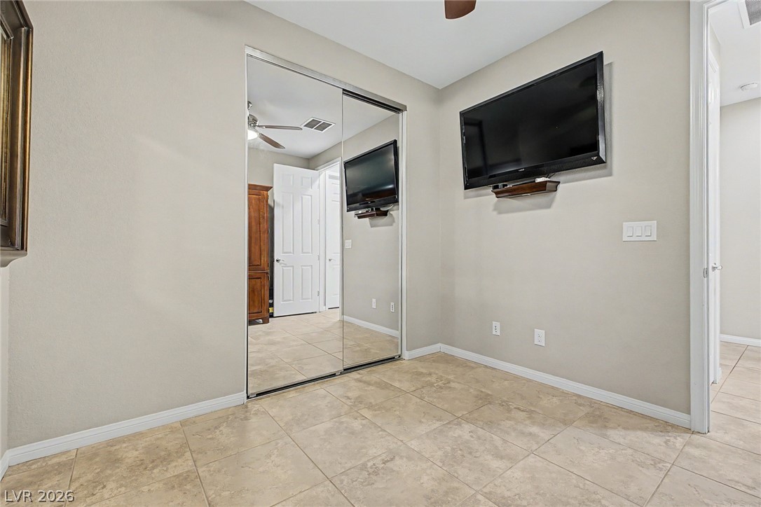 7415 Campbell Ranch Avenue Las Vegas, NV 89179 - Photo 37 of 52 This naturally illuminated space features tiled flooring, mirrored closet doors, and recessed lighting.