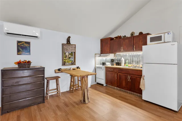 a kitchen with a refrigerator and a wooden cabinets