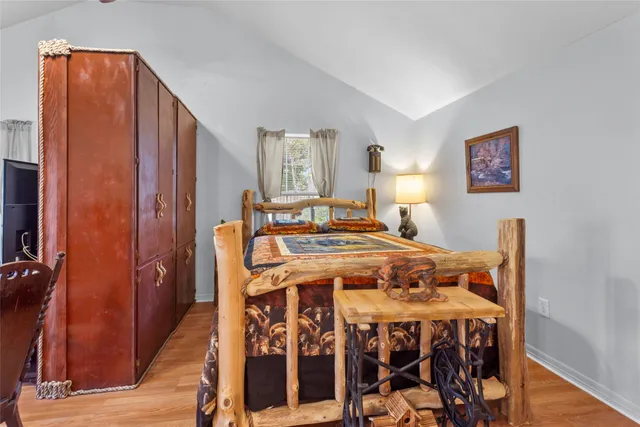 a bed sitting in a bedroom next to a window