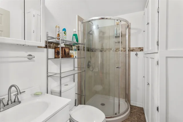 a bathroom with a sink toilet and shower