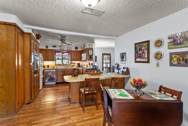 a dining room filled with lots of furniture and wooden floor