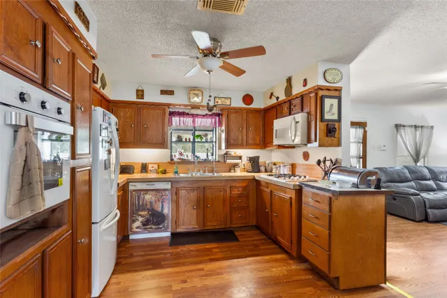 a kitchen with stainless steel appliances granite countertop a sink and cabinets