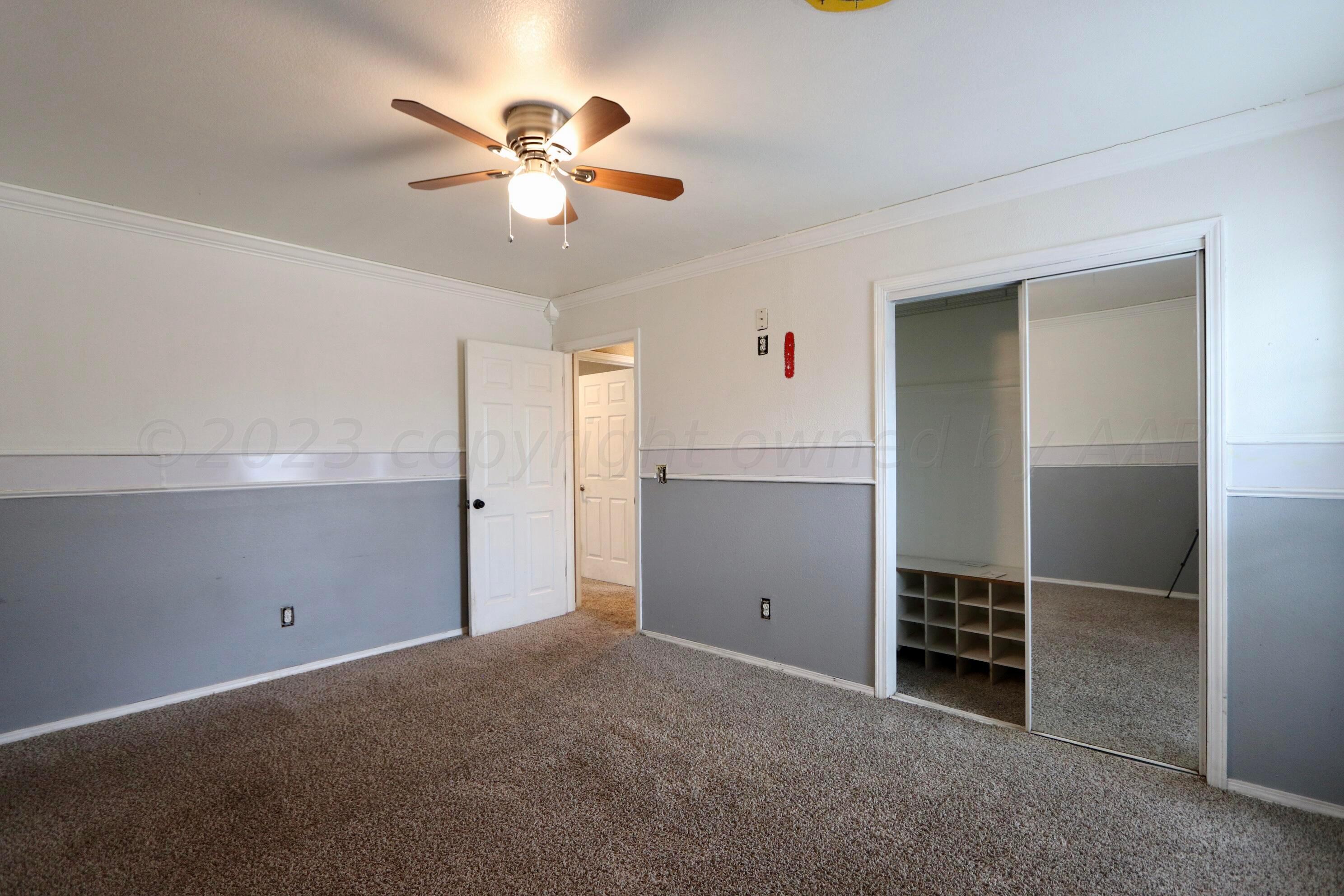 7916 Fenley Drive Amarillo, TX 79121 - Photo 13 of 23 a view of an empty room with a ceiling fan