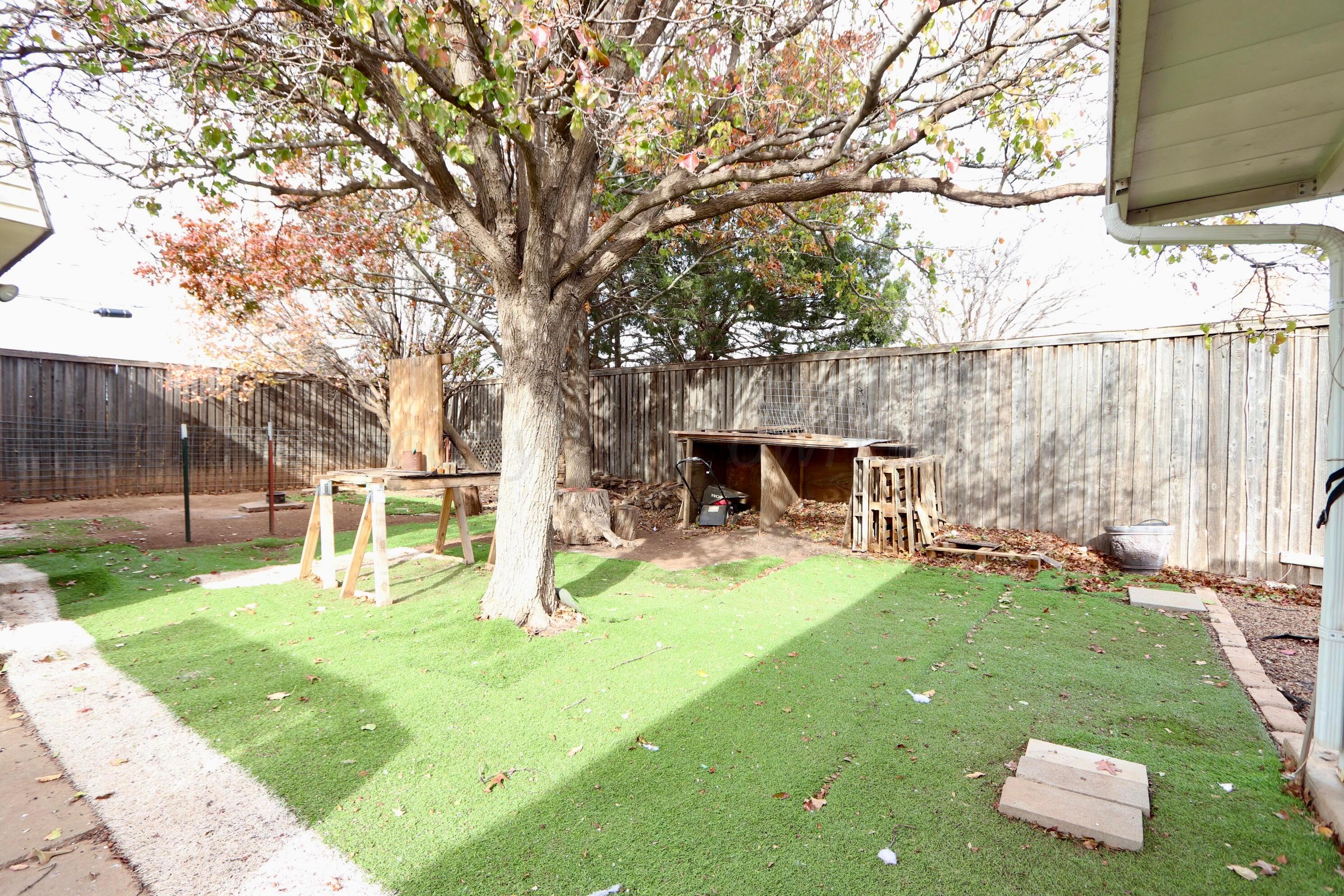 7916 Fenley Drive Amarillo, TX 79121 - Photo 18 of 23 a view of a backyard with table and chairs and a fire pit