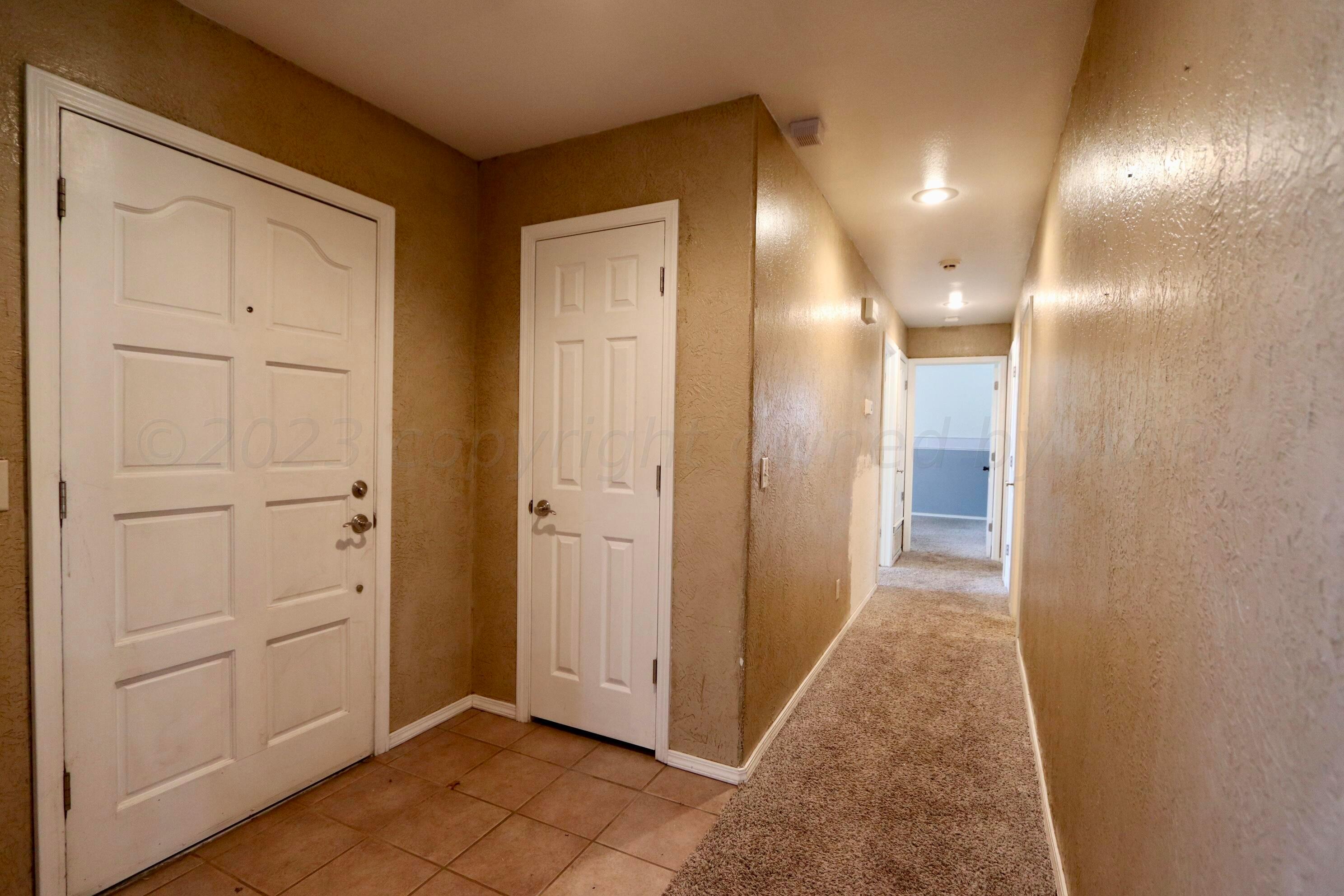 7916 Fenley Drive Amarillo, TX 79121 - Photo 2 of 23 a view of a hallway with wooden floor