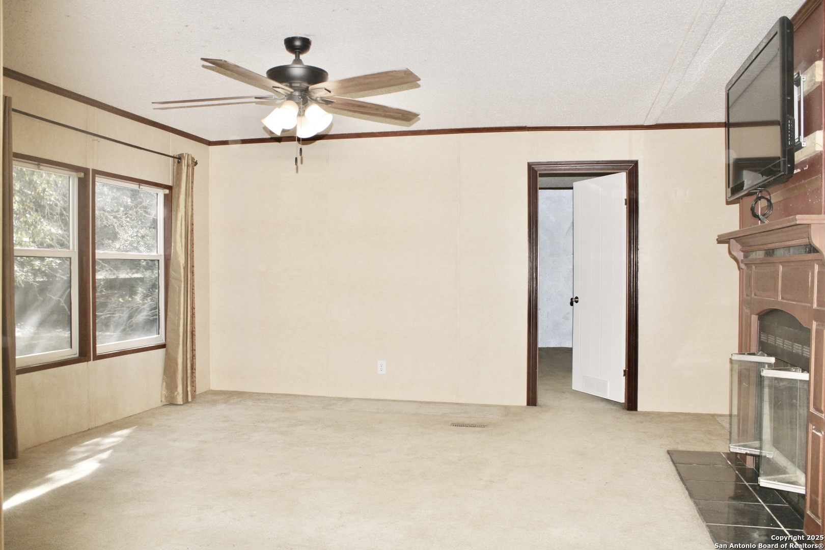 285 Rhonda Drive Lytle, TX 78052 - Photo 20 of 51 a view of empty room with a ceiling fan and a large window