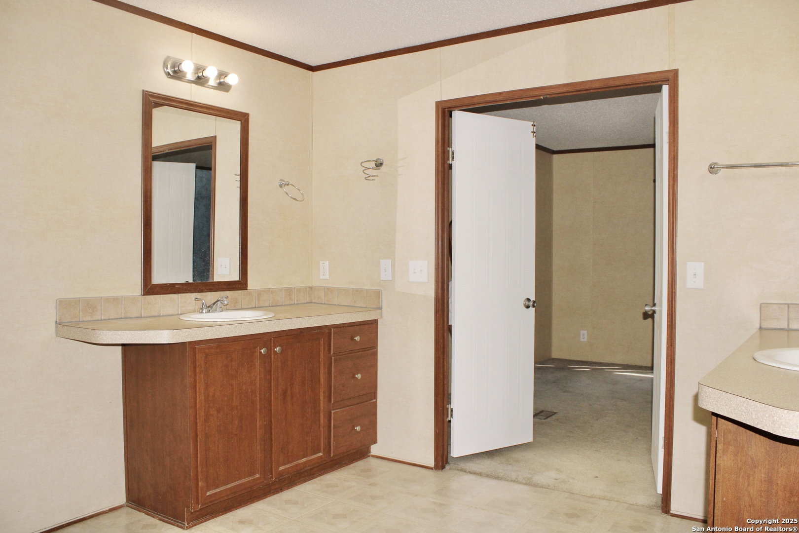 285 Rhonda Drive Lytle, TX 78052 - Photo 23 of 51 a bathroom with a granite countertop sink and a mirror