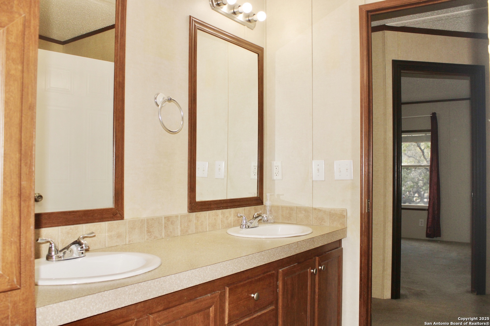 285 Rhonda Drive Lytle, TX 78052 - Photo 30 of 51 a bathroom with a granite countertop sink and a mirror